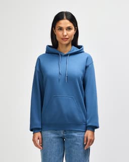 A blue Gildan Heavy Blend adult hooded sweatshirt on a model, featuring a front pocket and a drawstring hood.