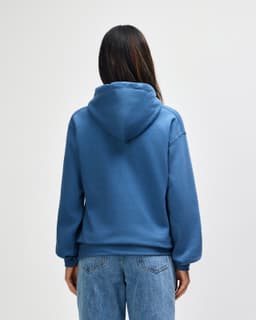 A back view of a blue Gildan Heavy Blend adult hooded sweatshirt, featuring a hood and casual fit.