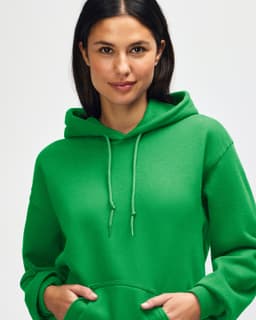A green hooded sweatshirt featuring a woman with long hair, wearing the hood and posing. The sweatshirt has a logo.
