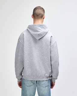A grey Gildan Heavy Blend adult hooded sweatshirt with a large hood, viewed from the back.