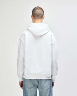 A white Gildan Heavy Blend adult hooded sweatshirt viewed from the back, featuring a hood and a plain design.