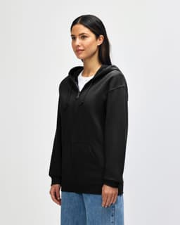 A black Gildan Heavy Blend adult full zip hooded sweatshirt on a model, featuring a front zipper and logo.