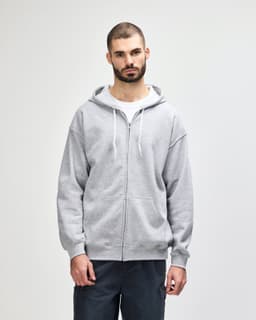 A grey full zip hooded sweatshirt worn by a man, featuring a front zipper and drawstring hood. It has a logo.