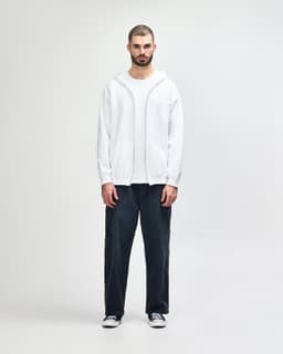 A white Gildan Heavy Blend full zip hooded sweatshirt worn with black pants and sneakers, featuring a front pouch pocket.