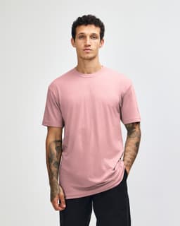 A unisex CVC short sleeve t-shirt in a soft pink colour, featuring a simple design and a logo.