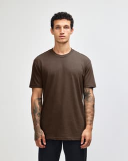 A unisex short sleeve t-shirt in brown, featuring a relaxed fit and a simple design. It has a branding logo.