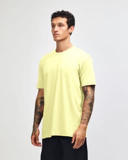 A unisex CVC short sleeve t-shirt in bright yellow, displayed on a model against a neutral background.