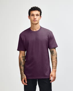 A unisex short sleeve T-shirt in a deep purple colour, featuring a relaxed fit and a visible logo.