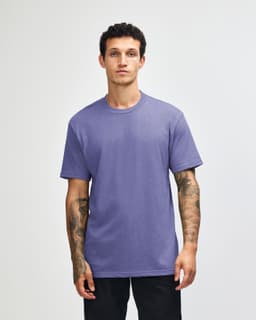 A unisex short sleeve T-shirt in a vibrant purple colour, featuring a simple design and a logo.