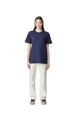 A unisex short sleeve t-shirt in navy blue, displayed on a model wearing light-coloured pants. The shirt features a logo.
