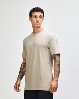 A unisex short sleeve T-shirt in a muted green colour with a simple design and a branding logo.