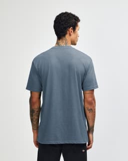 A unisex short sleeve T-shirt in a blue hue, featuring a simple design and a brand logo.