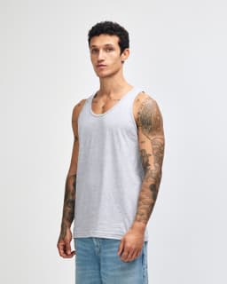 A unisex fine jersey tank in grey, featuring a logo, displayed by a model wearing casual jeans.