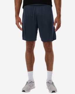 Men's Pro-Lock Performance Short in navy blue, featuring an elastic waistband and a logo. Model standing in sports shoes.