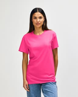 A pink Gildan Heavy Cotton adult T-shirt displayed on a model with a neutral background. The shirt features a logo.