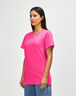 A pink Gildan Heavy Cotton Adult T-Shirt with a crew neck and short sleeves, displayed on a model.