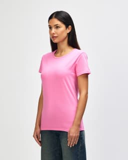 A pink Gildan Heavy Cotton ladies' T-shirt displayed on a model, showcasing a round neckline and short sleeves.