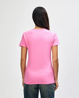 A pink Gildan Heavy Cotton Ladies' T-Shirt is displayed from the back, featuring a simple design and a relaxed fit.