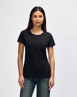 A black Gildan Heavy Cotton Ladies' T-Shirt displayed on a model, featuring short sleeves and a relaxed fit.