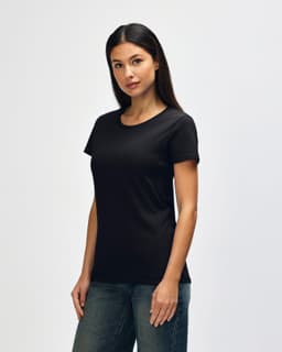 A black Gildan Heavy Cotton ladies' T-shirt displayed on a model. The product features a classic crew neck design.