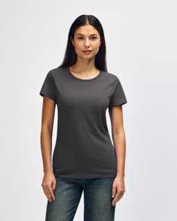 A woman models a dark grey Gildan Heavy Cotton ladies' T-shirt, featuring a classic crew neck and short sleeves.
