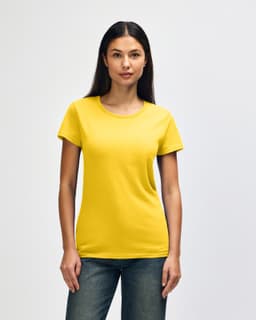 A yellow Gildan Heavy Cotton Ladies' T-Shirt displayed on a model with straight hair, paired with blue jeans.