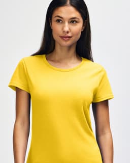 A yellow Gildan Heavy Cotton Ladies' T-Shirt displayed on a model, featuring a simple design and a logo.