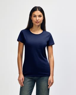 A navy blue Gildan Heavy Cotton ladies' T-shirt displayed on a model, featuring a logo on the sleeve.