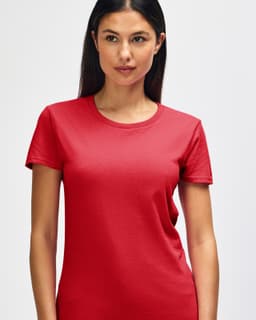 A red Gildan Heavy Cotton ladies' t-shirt is displayed, worn by a smiling woman. It features a logo on the shirt.