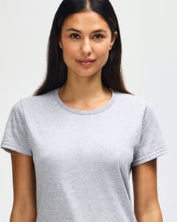 A grey ladies' T-shirt made from heavy cotton, featuring a round neck and short sleeves. It has a logo on it.