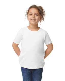 A toddler wearing a plain white short-sleeve T-shirt, smiling and posing against a neutral background.