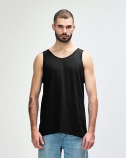 A black Gildan Heavy Cotton adult tank top on a model, featuring a plain design and a logo on the label.
