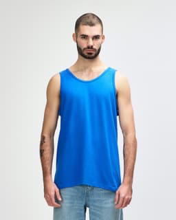 A blue Gildan Heavy Cotton adult tank top on a male model, featuring a plain design and a logo.
