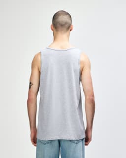 A grey Gildan Heavy Cotton adult tank top, featuring a simple design and a back view of the garment.