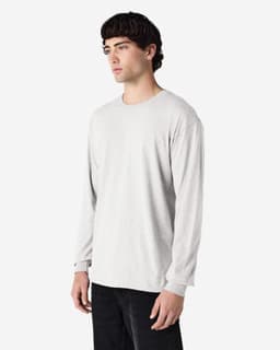 A long sleeve t-shirt in light grey, featuring a simple design and a logo on the chest.