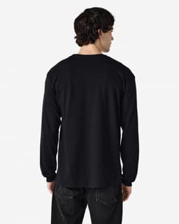 A man is wearing a black long sleeve t-shirt, viewed from the back. The shirt has a logo on it.