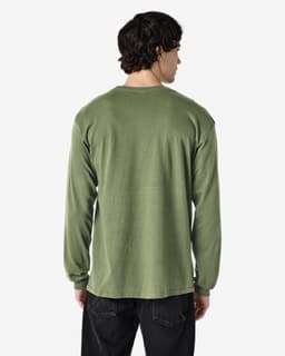 A long sleeve t-shirt in olive green, featuring a simple design with a logo on the back.