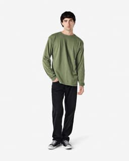A long sleeve shirt in olive green, featuring a simple design with a logo, paired with black jeans.