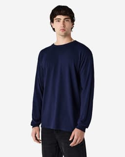 A navy long sleeve T-shirt on a male model. The shirt features a simple design and has a logo.