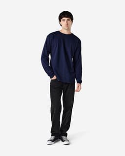 A navy Gildan Heavy Cotton adult long sleeve T-shirt displayed on a model, paired with black jeans and sneakers.