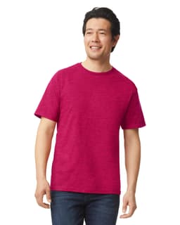 A man wearing a bright pink Gildan Softstyle adult T-shirt, paired with dark jeans. The shirt has a logo.