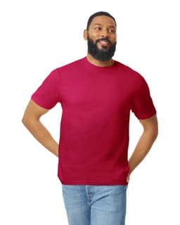 A man wearing a burgundy Gildan Softstyle adult T-shirt paired with blue jeans, smiling. The shirt features a logo.
