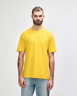 A yellow Gildan Softstyle adult t-shirt displayed on a model, featuring a logo on the shirt.