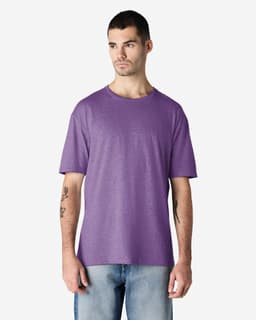 A purple Gildan Softstyle adult T-shirt displayed on a male model, featuring a casual fit and a logo.