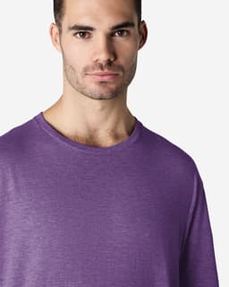 A man wearing a purple Gildan Softstyle adult T-shirt, featuring a round neckline and short sleeves.