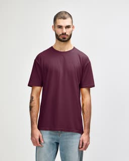 A maroon Gildan Softstyle adult t-shirt displayed on a male model against a neutral background. The shirt has a brand logo.
