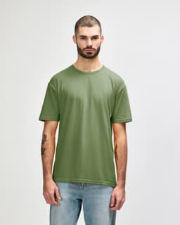 A green Gildan Softstyle adult t-shirt displayed on a male model. The t-shirt has a round neckline and short sleeves.