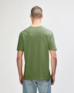 A green Gildan Softstyle adult T-shirt viewed from the back, featuring a simple design and a relaxed fit.