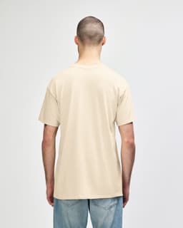 A beige Gildan Softstyle adult t-shirt displayed from the back, with a plain design and a subtle logo.