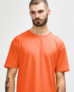 An adult t-shirt in bright orange, featuring a relaxed fit and a crew neck. It has a logo displayed.